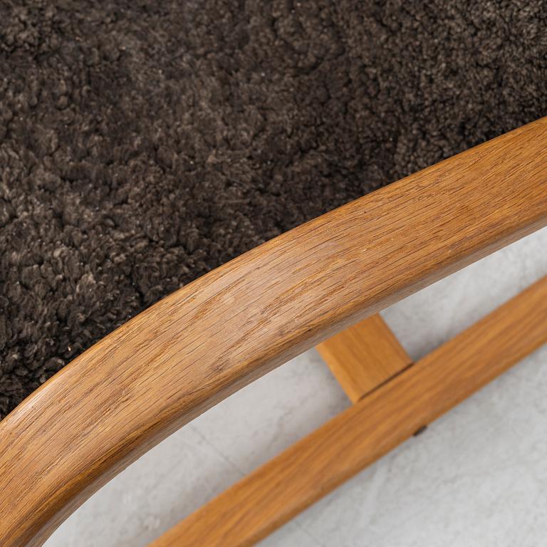 Jan Ekström, a "Gazell" armchair with a footstool, 21st century.