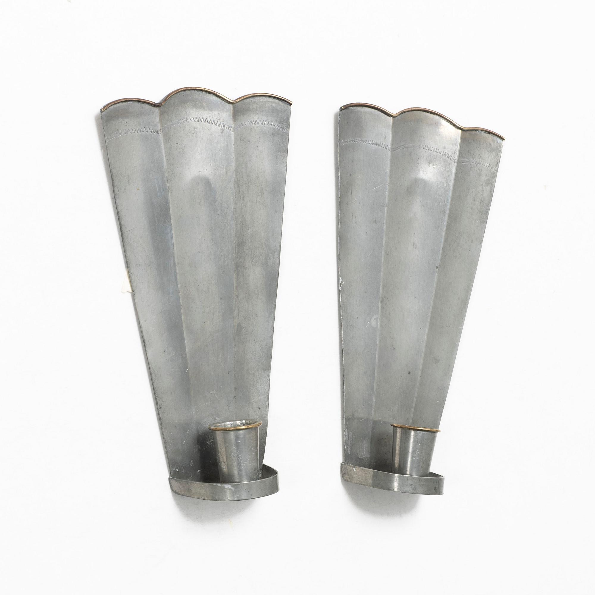 Nils Fougstedt, a matched pair of pewter and brass wall sconces, model A 60, Svenskt Tenn, Stockholm 1929 and 1932.