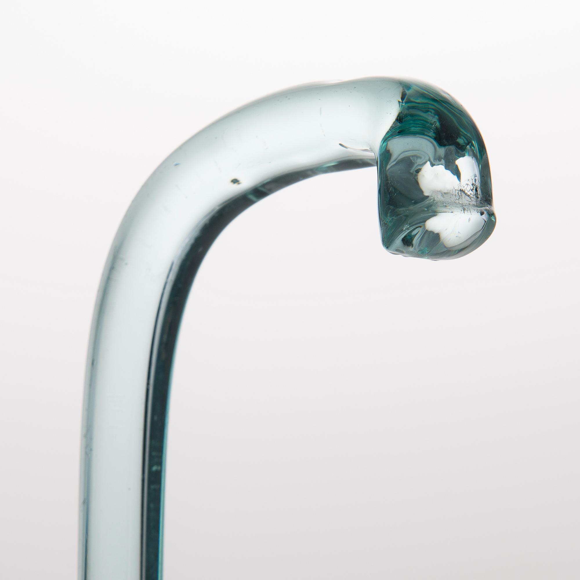 A greenish glass walking stick.