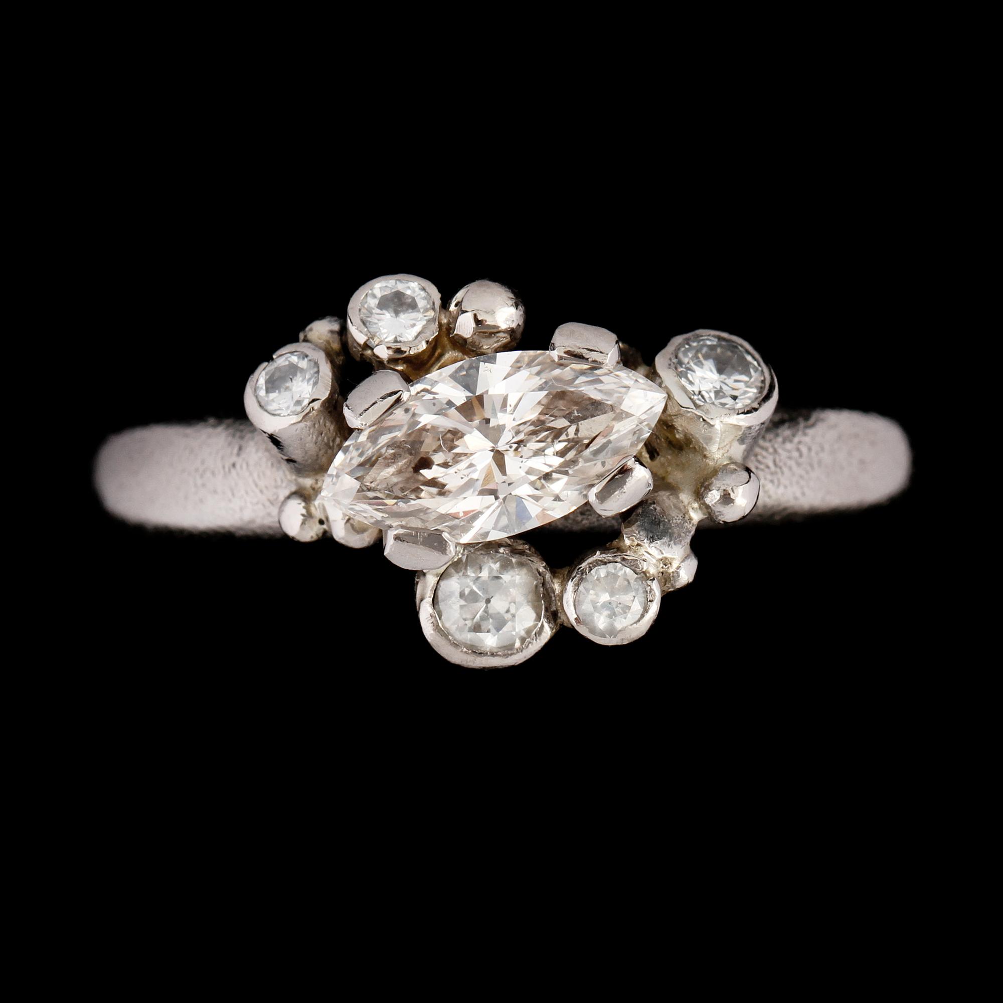 RING, 14k vitguld med 5 briljantslipade och en navettslipad diamant. Vikt 13,7 g.