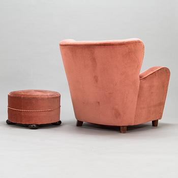 A mid-20th century armchair and ottoman.