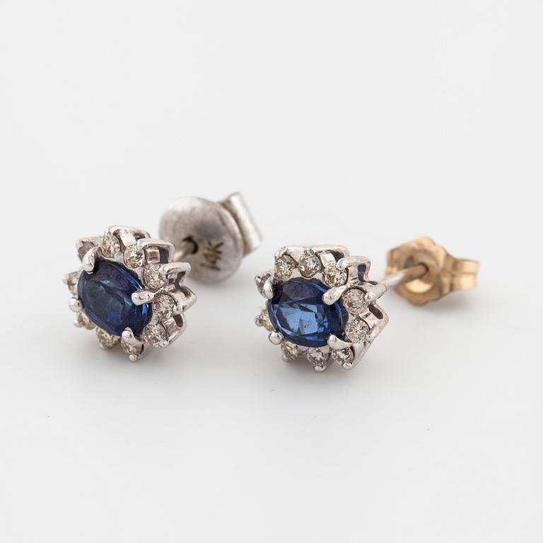 A pair of brilliant cut diamond and sapphire earrings.