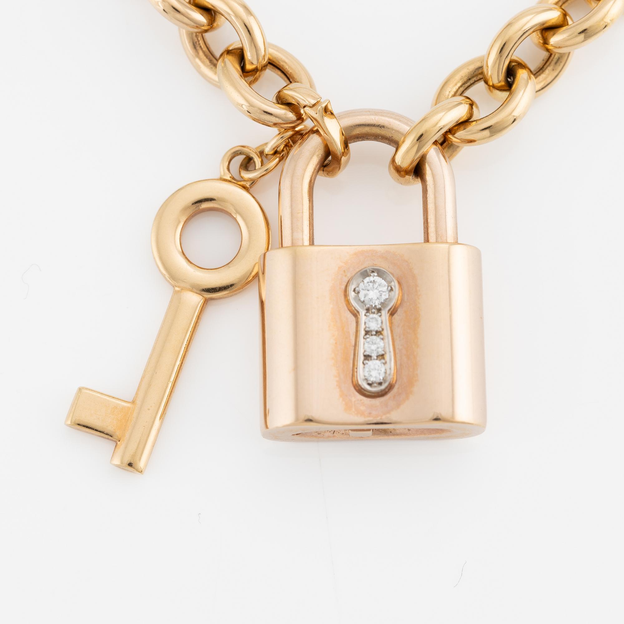 Collier, 18K guld, Gübelin, med 
berlock/hänge i form av lås Gübelin med briljantslipade diamanter.