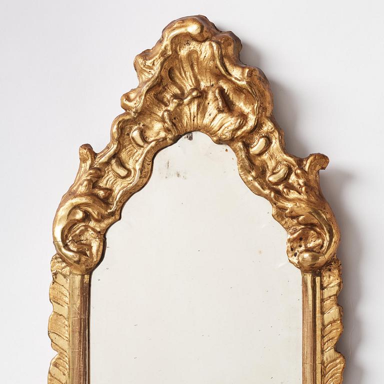 A pair of presumably German rococo giltwood one-branch mirrored wall-sconces, mid 18th century.