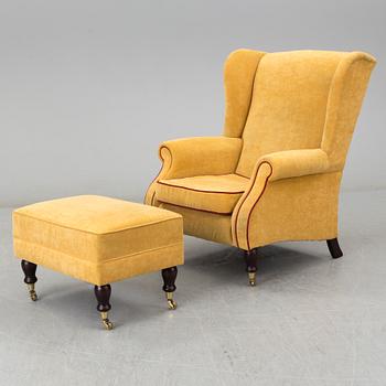 A 'York Wing Chair' easy chair with foot stool from Parker Knoll, 21st Century.