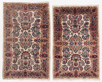 A pair of similar Kirman rugs, south Persia, c. 147 x 94 and 154 x 96 cm.