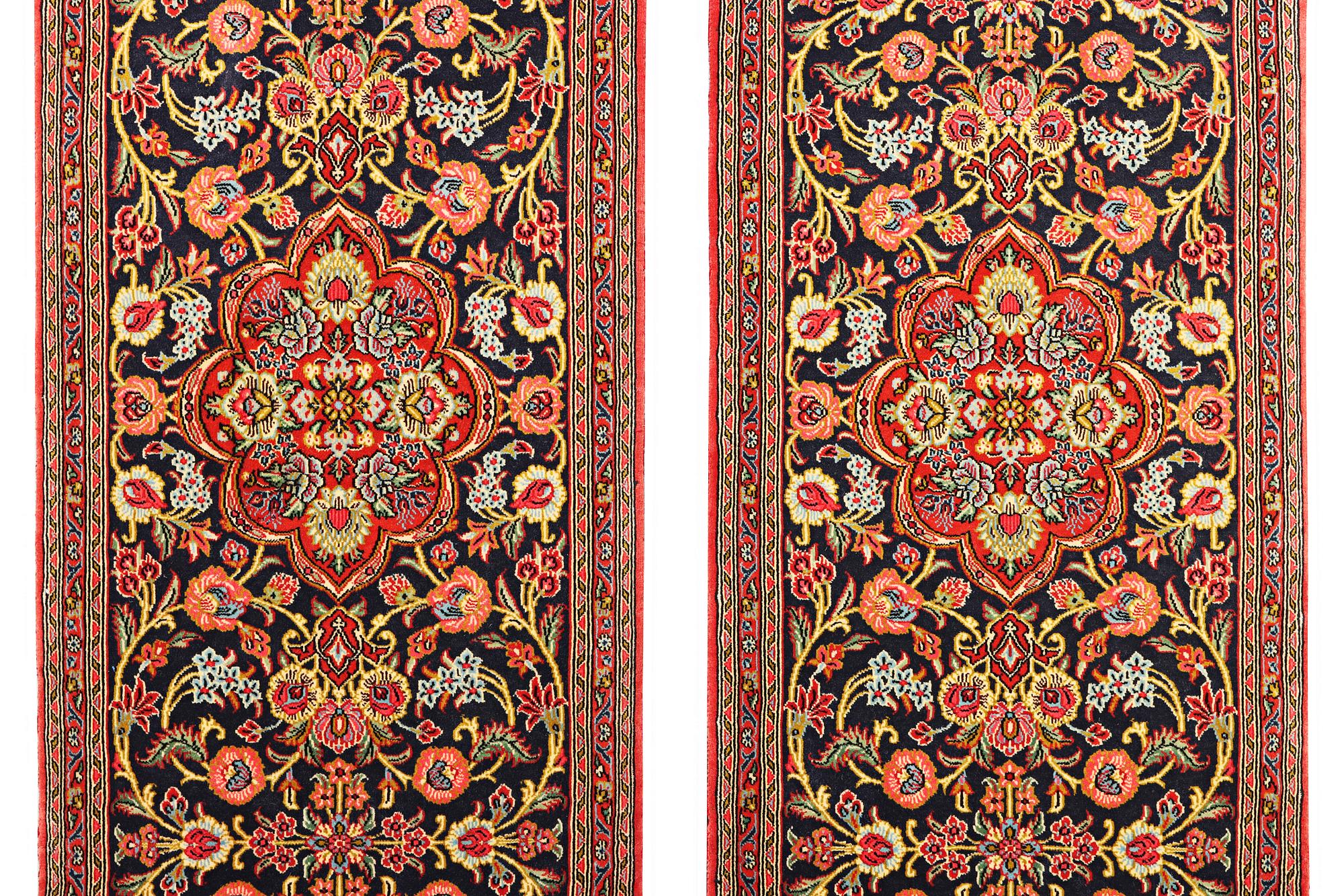 A pair of Quum rugs, c. 176 x 60 cm & c. 178 x 58 cm.