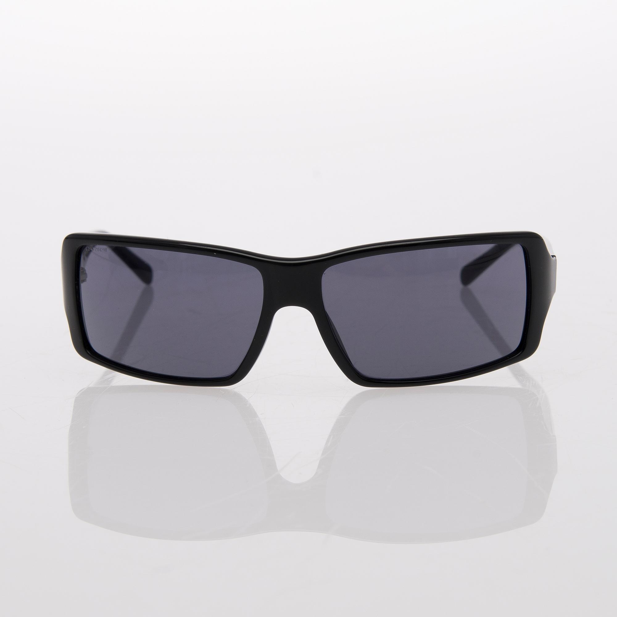 Two Pairs of Sunglasses, Prada and Chanel.