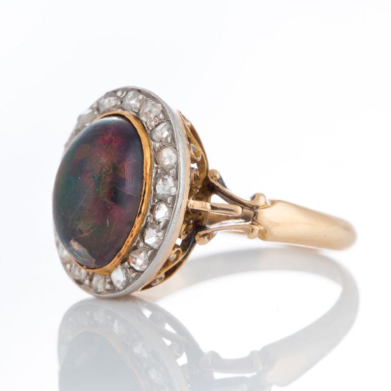 An opal ring set with rose-cut diamonds.