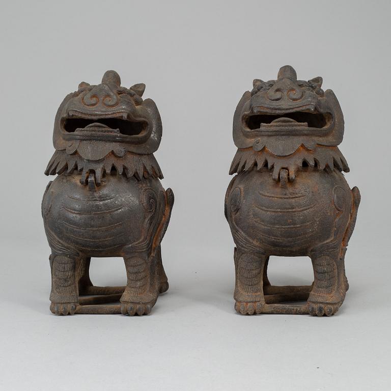 A pair of Chinese iron Fo dogs, 20th Century.