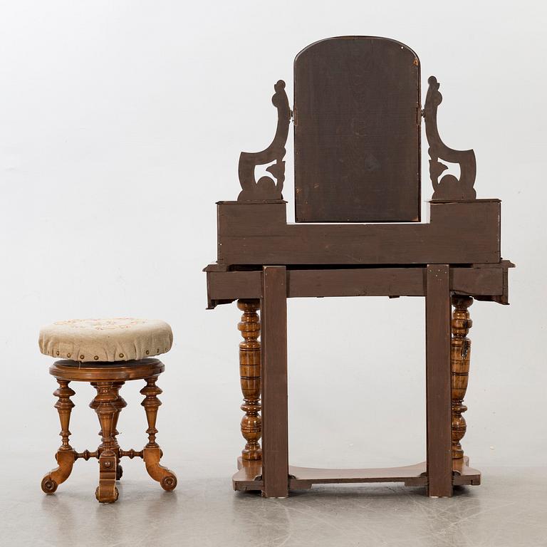 A second half of the 19th century table with mirror and a stool.
