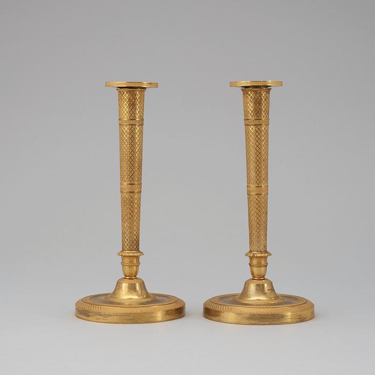 A pair of French Empire early 19th century candlesticks.