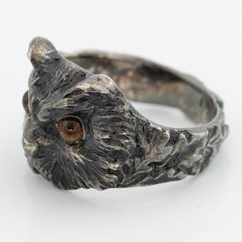 Ring in the form of an owl, silver with orange stone.