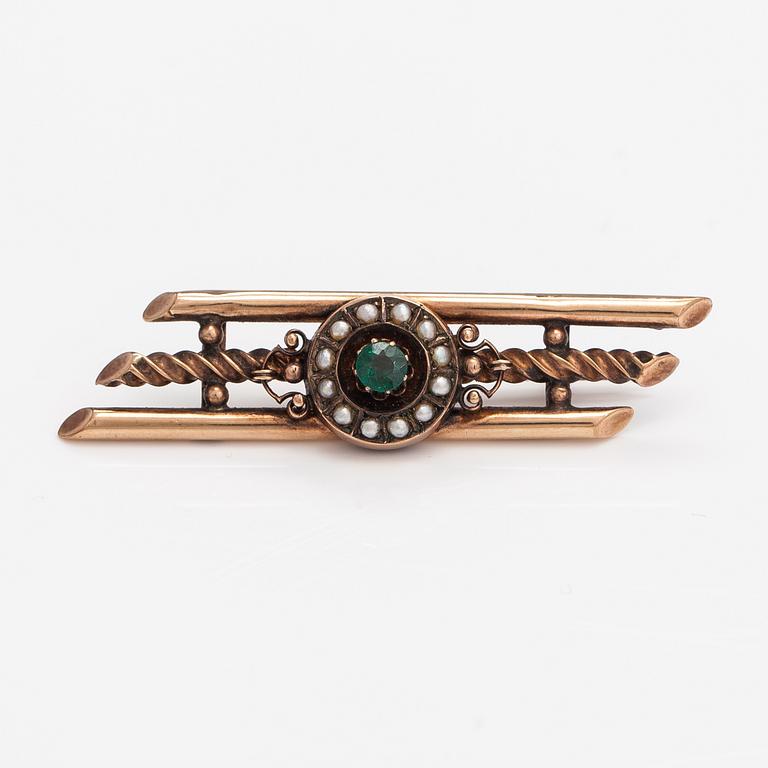 A 14K gold brooch with pearls and garnet glass doublet.