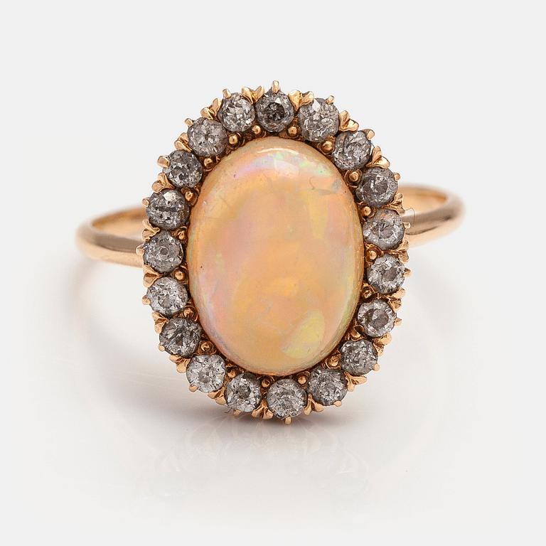 A 14-17K gold ring with a ca. 3.50 ct opal and old-cut diamonds ca. 0.57 ct in total according to certificate.