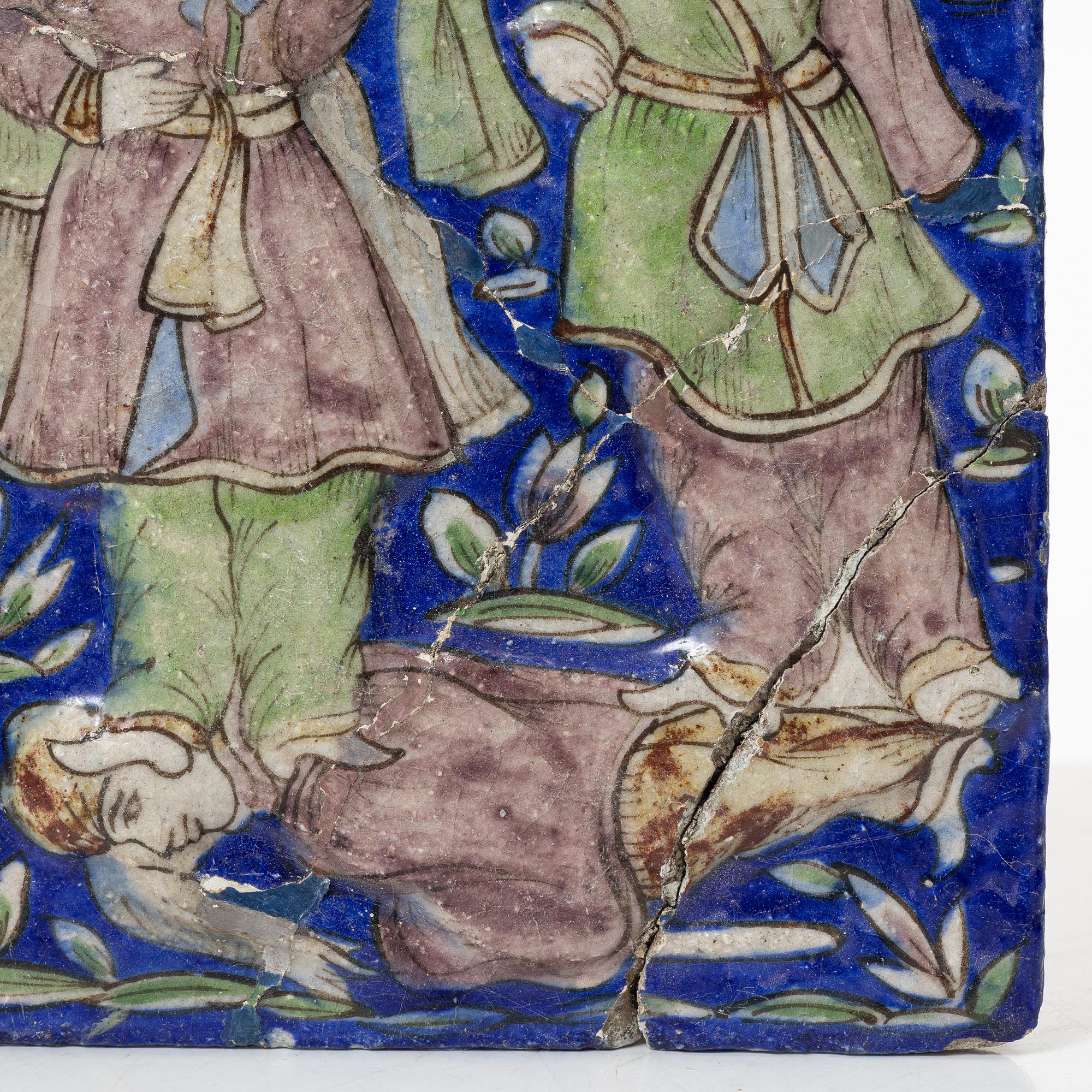 A Qajar moulded figural pottery tile, ca 26 x 19 cm.