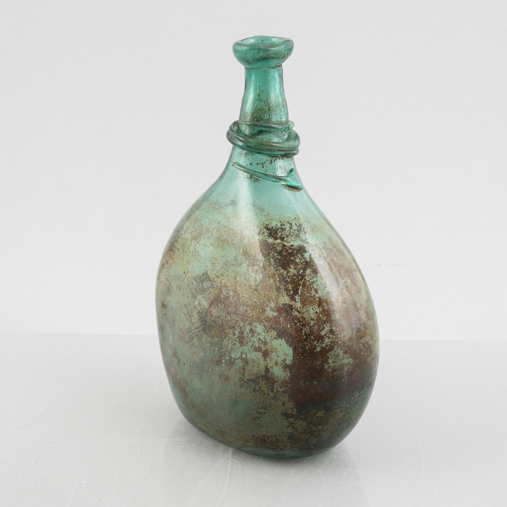 A turquoise tinted glass bottle, 19th century.