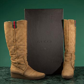 A pair of boots by GUCCI in size 39.