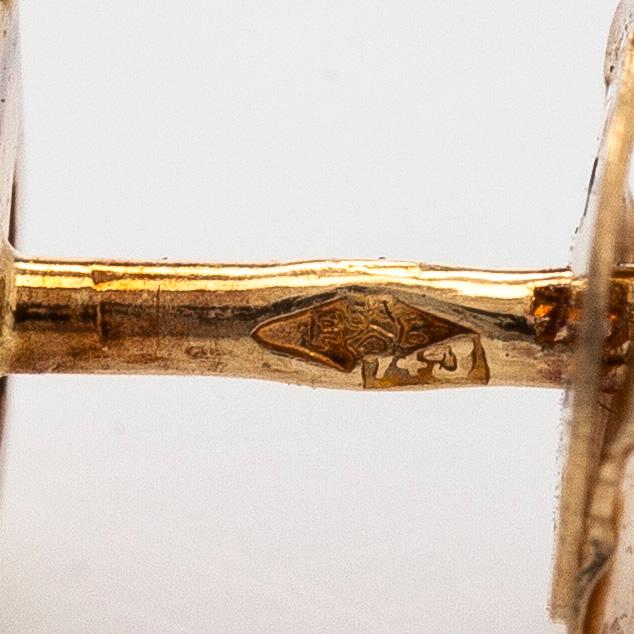 A pair of 18K gold earrings, with round brilliant-cut diamonds.