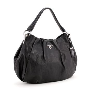 556. PRADA, a black leather shoulder bag.