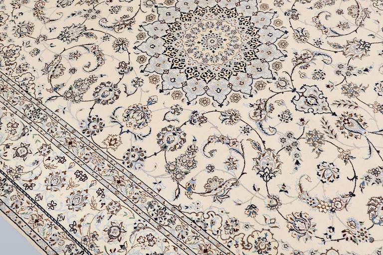 A Nain, part silk carpet, 305 x 207 cm.
