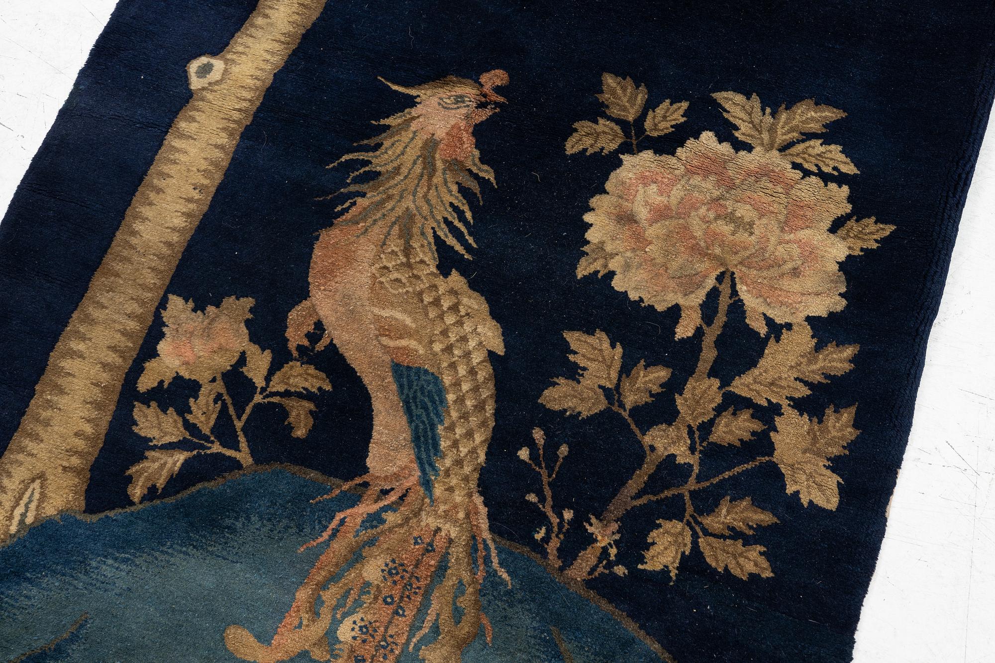 A Chinese ’phoenix rug’, 20th century, c. 181 x 93 cm.