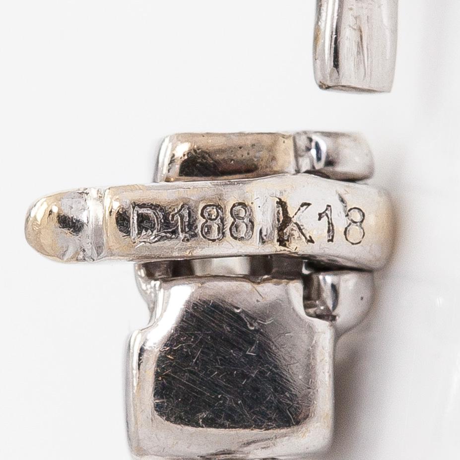 An 18K white gold bracelet set with baguette and brilliant-cut diamonds.