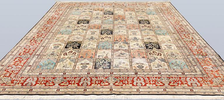 An oriental silk carpet, approx. 376 x 274 cm.