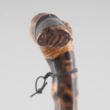 A carved wooden cane, 19th century.