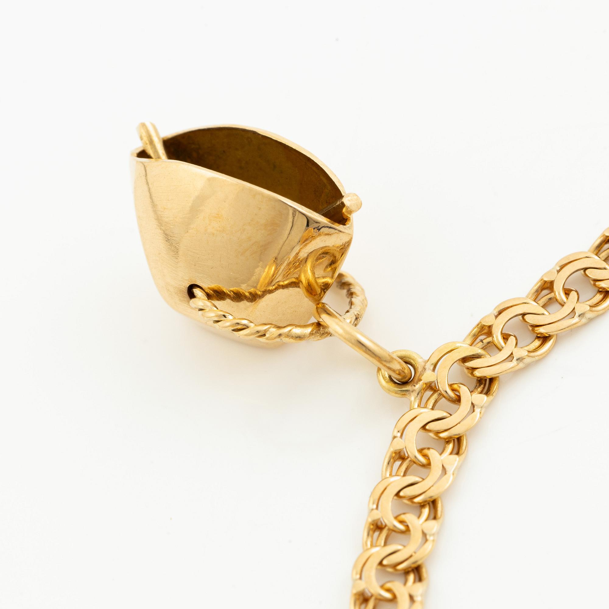 Bracelet, 18K gold bismarck link. With charms.
