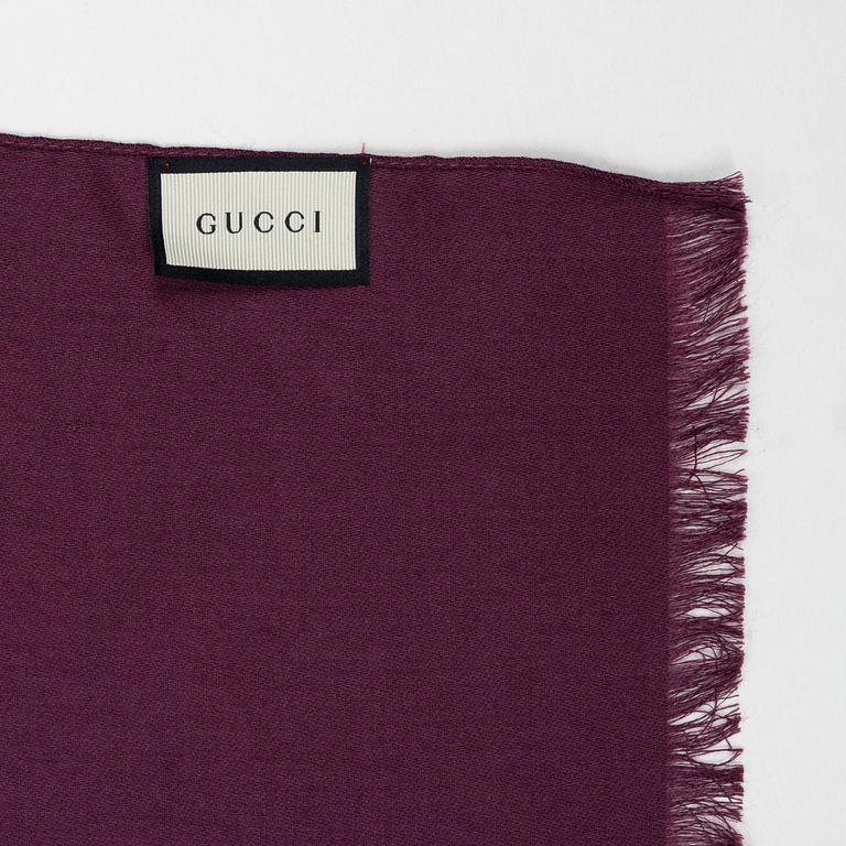 Gucci, a wool and silk mix "GG" jaquard shawl.