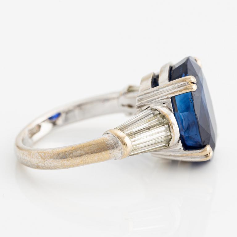 Ring in 18K white gold with a faceted oval sapphire and modified baguette-cut diamonds.