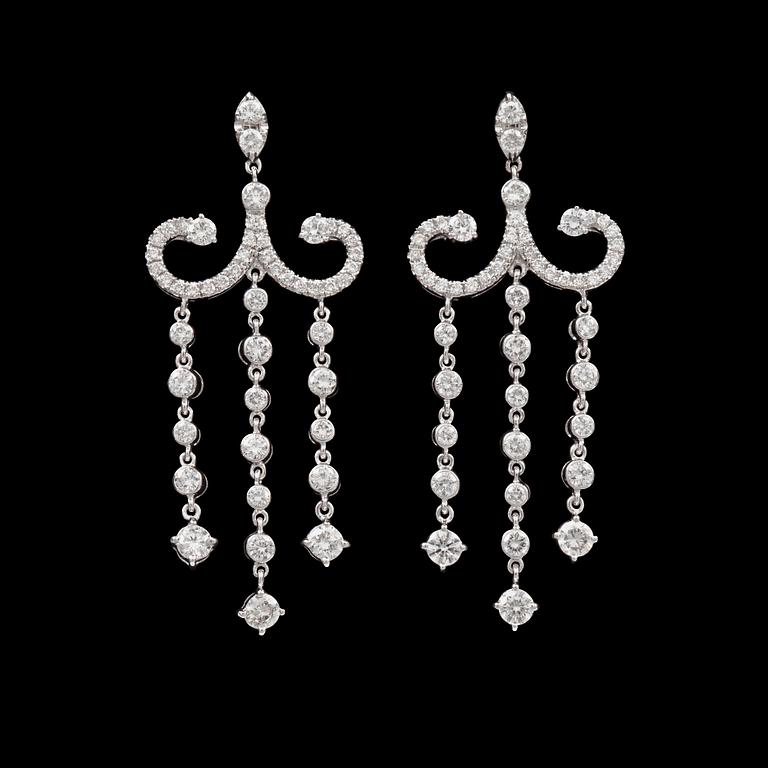 A pair of diamond earrings. Total carat weight 3.14 cts.