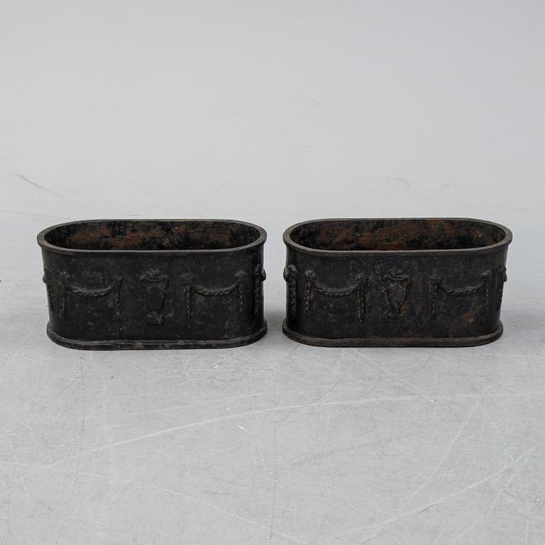 A pair of 20th century cast iron plant pots.