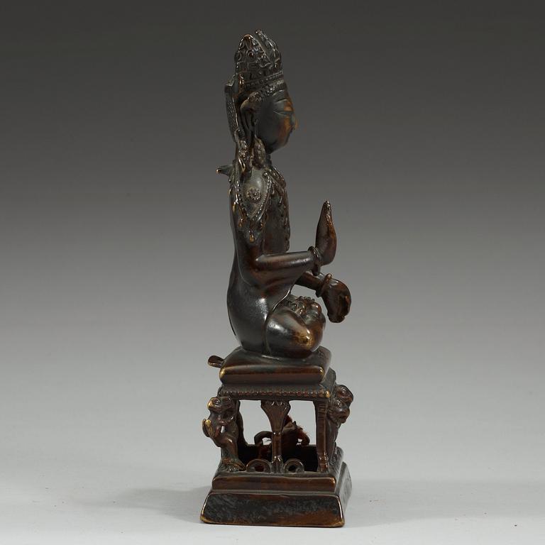 A western Tibetan/Kashmir bronze figure of Maitreya on a high throne, presumably 12th Century or older.