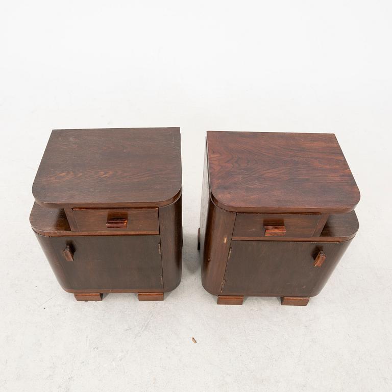 A pair of stained wood bedside tables from the first half of the 20th century.