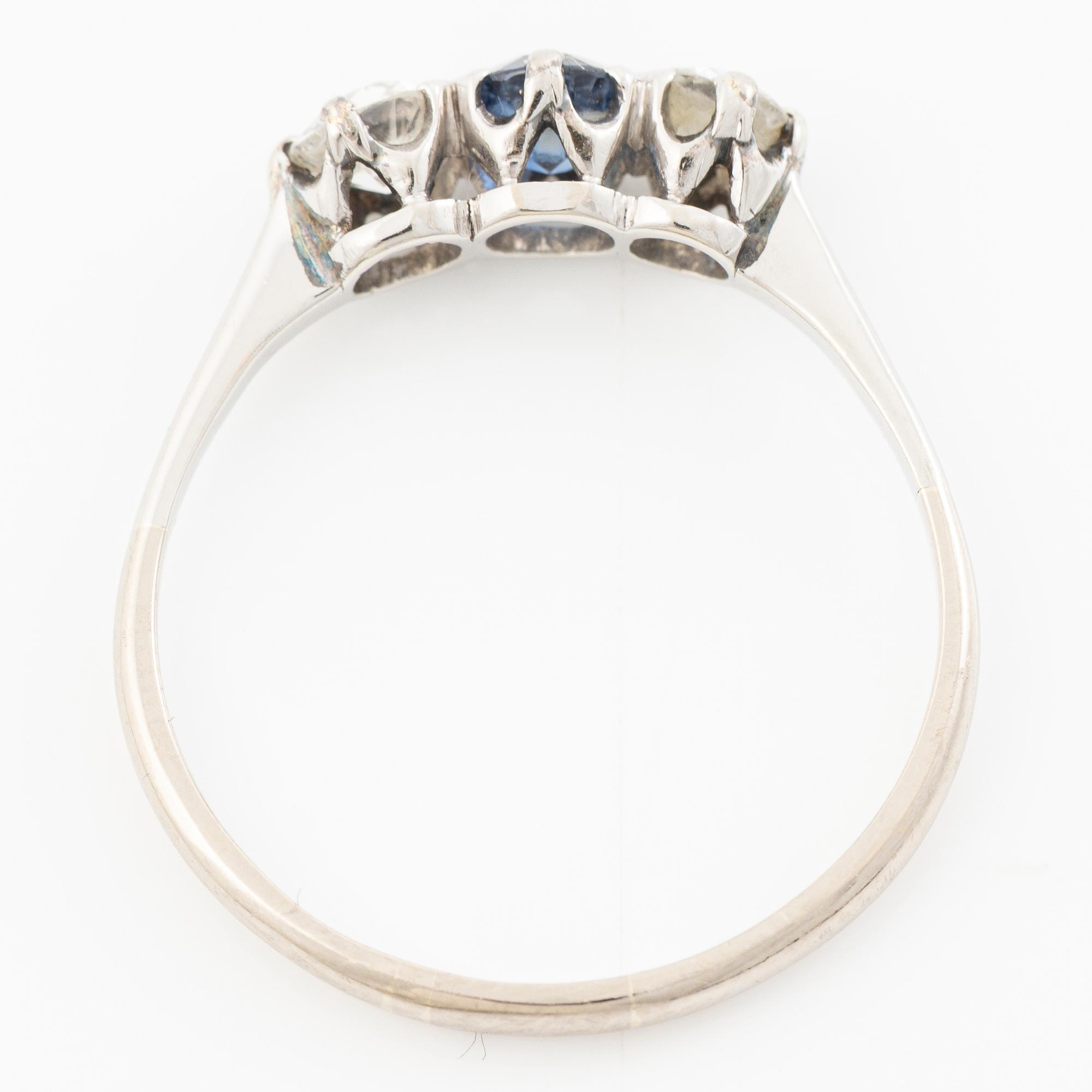 18K gold ring with two old-cut diamonds and a blue stone.