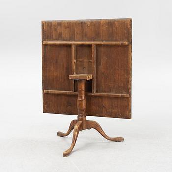 A root veneered tilt-top table, 19th Century.