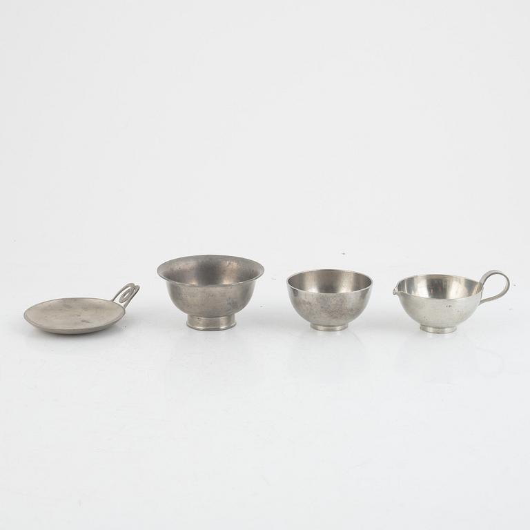 A pewter sugar bowl, cream jug, bowl and dish by Svenskt Tenn 1930s-1950s.