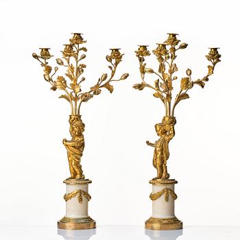 A pair of Louis XVI four light candelabra.