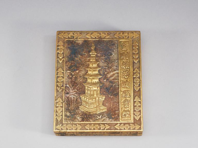 A repousse technique gilt metal box with a book of buddhistic prayers, China.