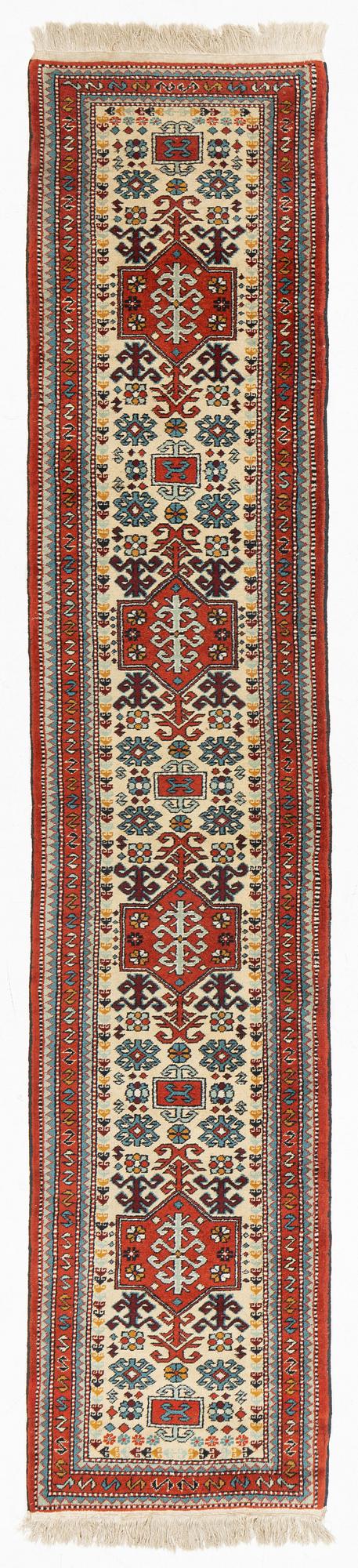 An oriental runner, c. 355 x 75 cm.
