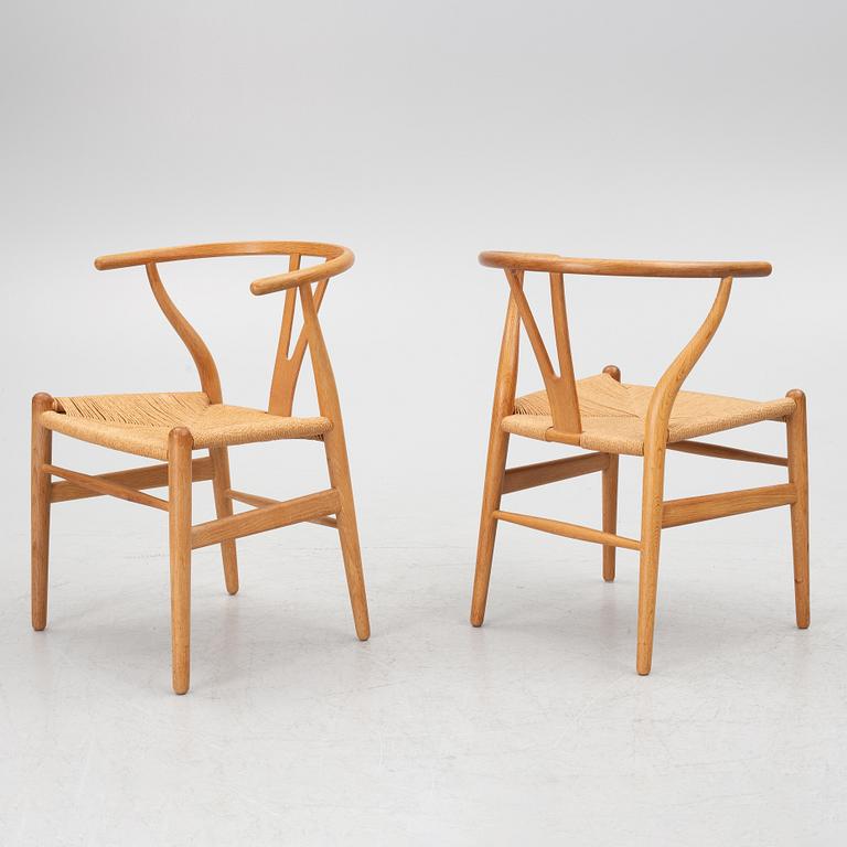 Hans J. Wegner, four model CH-24/ 'Wishbone' chairs, Carl Hansen, Odense, Denmark, second half of the 20th century.