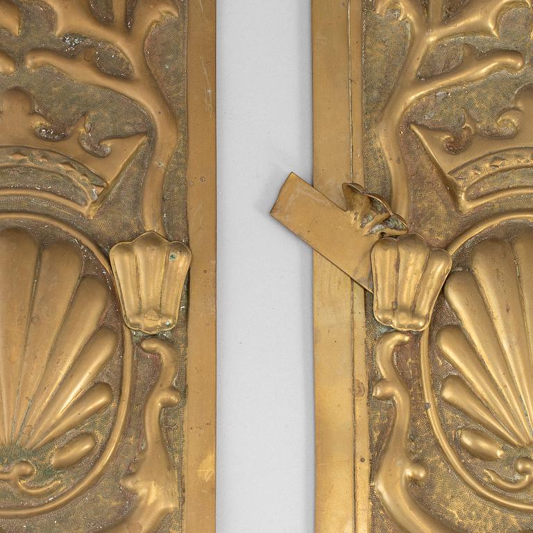 A pair of art nouveau brass oven hatches, early 20th century.