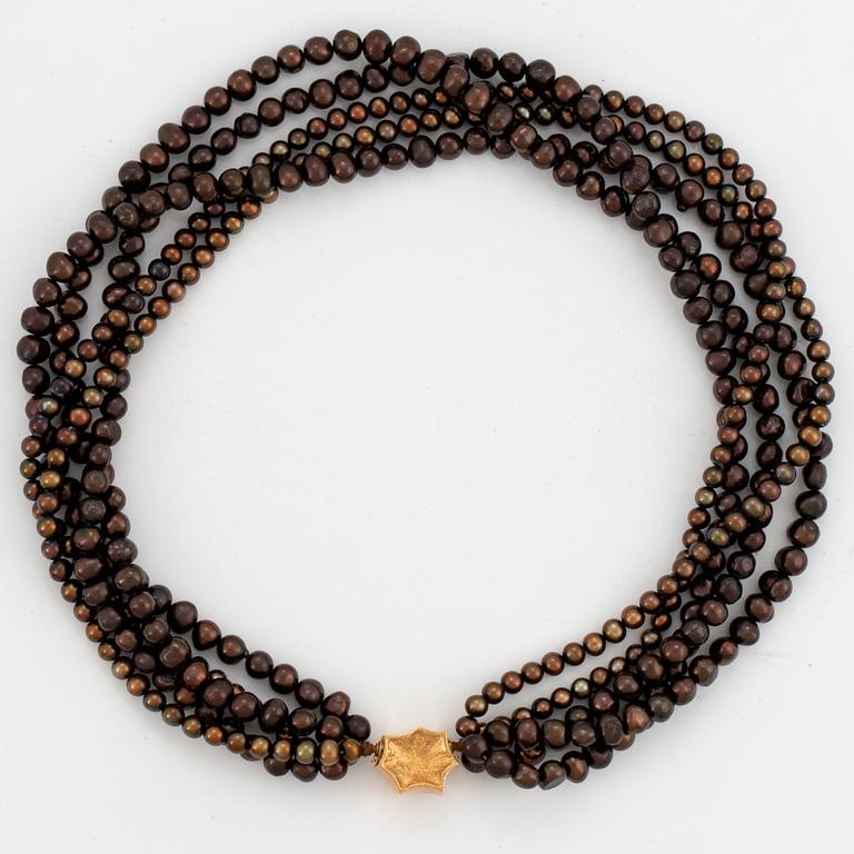 A five strand cultured pearl necklace.