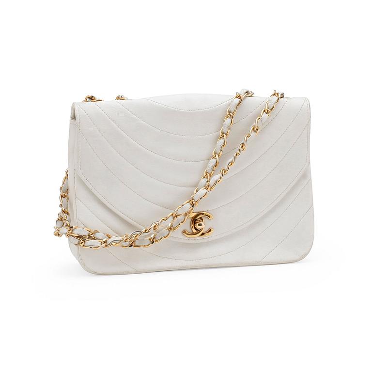 CHANEL, a white leather shoulder bag.