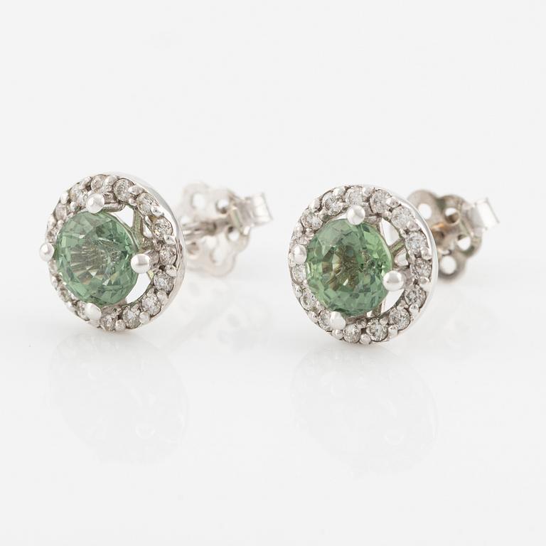 A pair of 18K gold earrings with green faceted sapphires and round brilliant-cut diamonds.