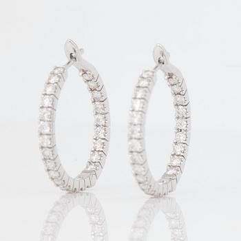 A pair of diamond, 2.303 cts according to engraving, loop earrings.