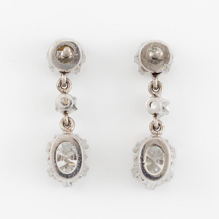 A pair earrings in 18K white gold set with round and oval brilliant-cut diamonds.