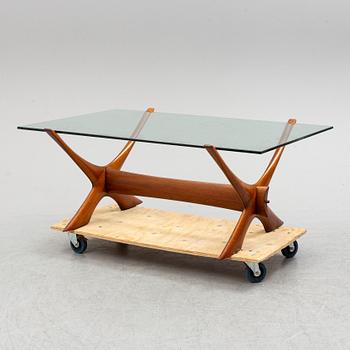 A glass top coffee table by Fredrik Schriever Abeln.